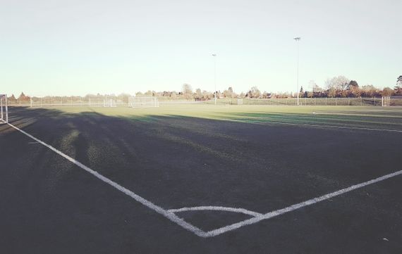 An empty football field seen from one corner.