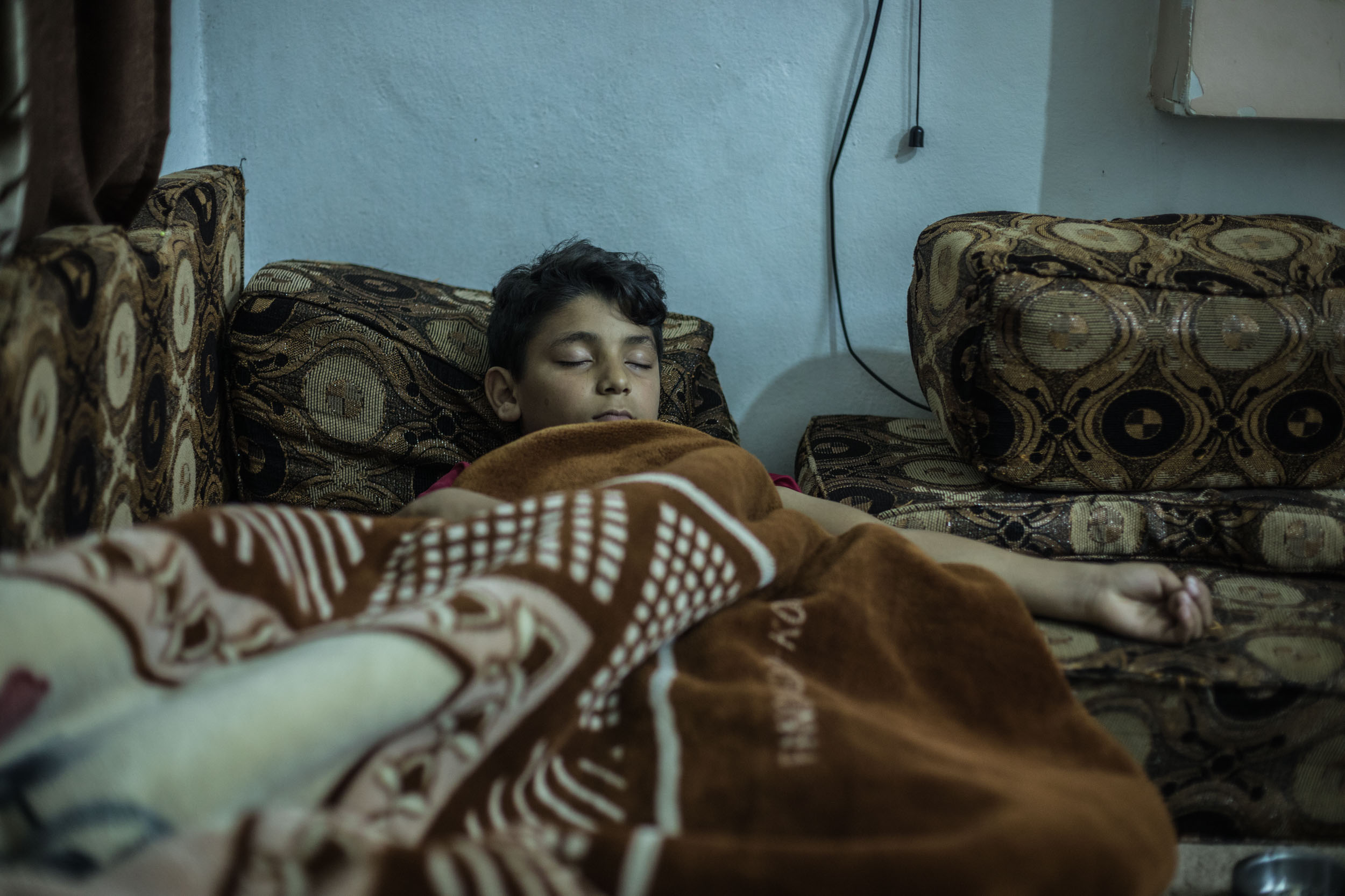 One of Mohammed's sons sleeping in their home in Jordan.
